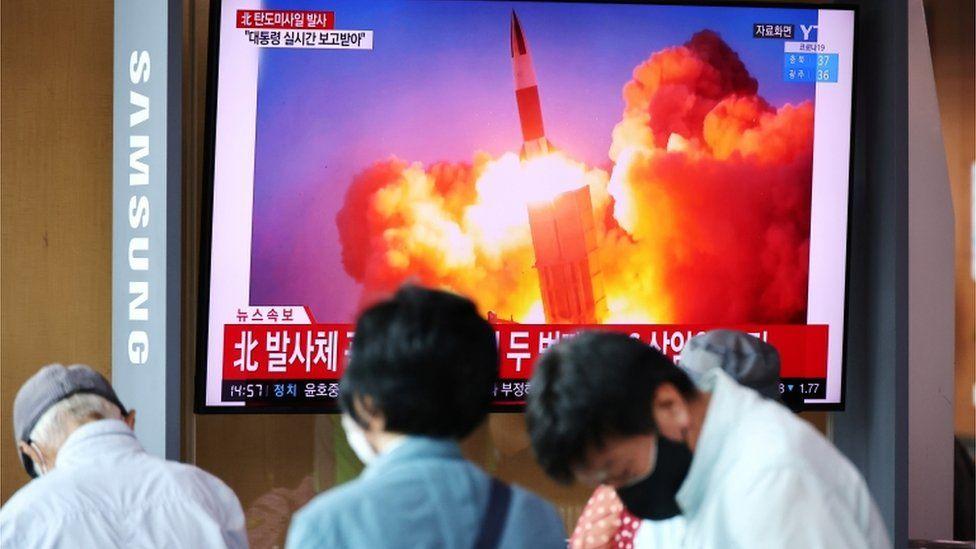 People watch a TV broadcasting file footage of a news report on North Korea firing what appeared to be a pair of ballistic missiles off its east coast, in Seoul