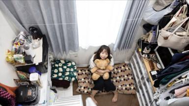 Woman sitting in tiny Tokyo flat