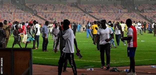 A pitch invasion at the Moshood Abiola National Stadium in Abuja
