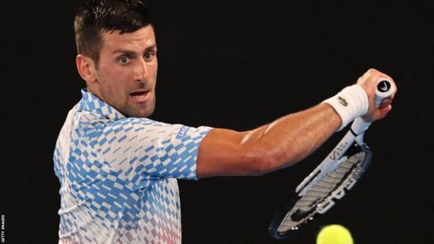 Novak Djokovic returns a ball in his Australian Open semi-final