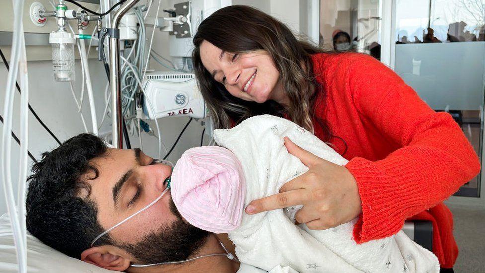 Mustafa Avci kissing his baby in hospital after being rescued 261 hours after quake